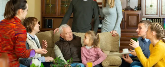 Multi-generational family in a living room discussing care options—family conflict over assisted living.