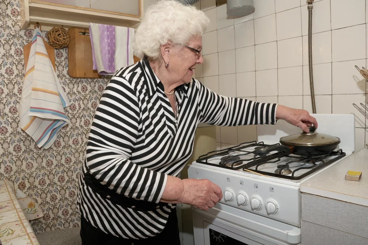Signs It Might Be Time for Assisted Living Senior woman preparing food at home, one of the daily living changes families may notice when looking for signs it might be time for assisted living.